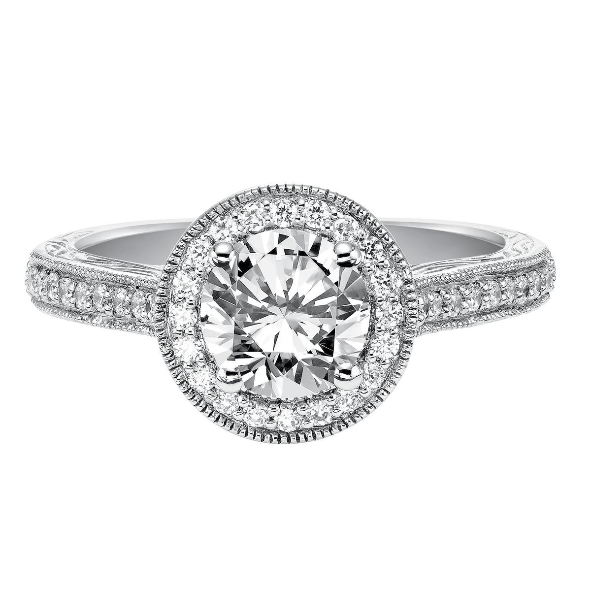 This captivating vintage inspired diamond halo engagement ring features a diamond and milgrain band with a delicate engraved design to complete to the look