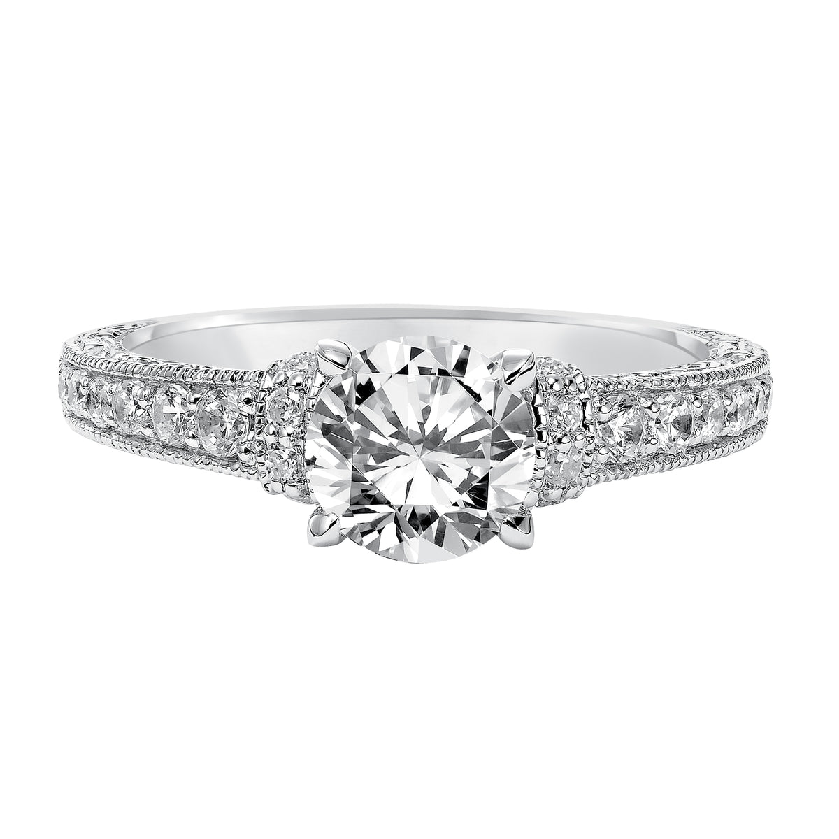Intricately designed, this engagement ring is spectacular with its prong set diamond band, delicate engraving and milgrain