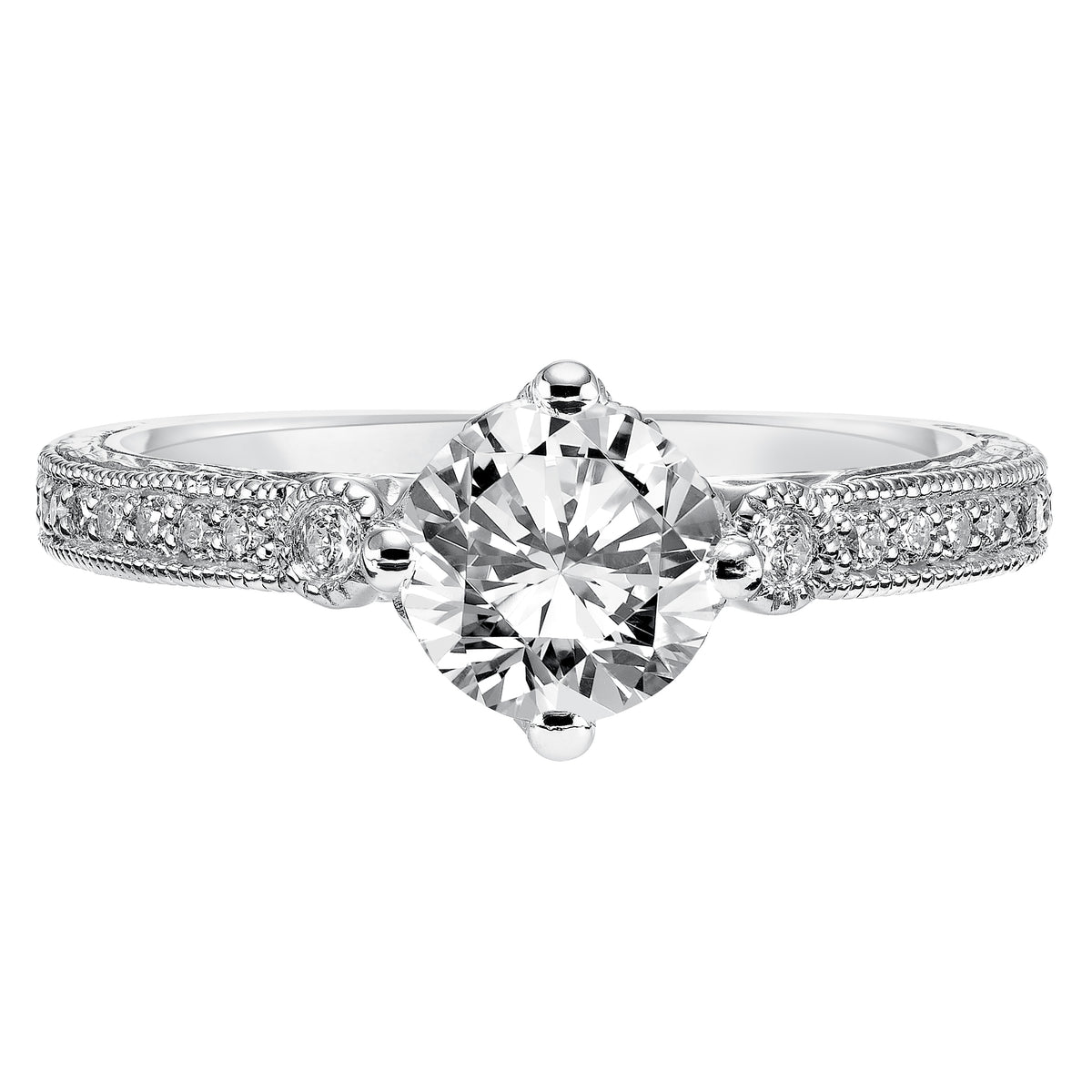 Prong set diamonds, milgrain details and an engraved design grace the band of this exquisite round diamond engagement ring