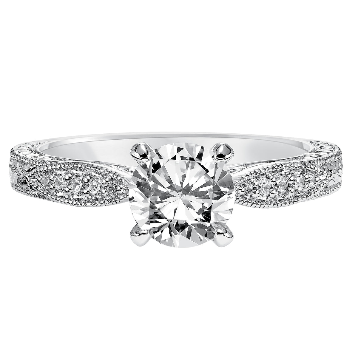 Absolutely exquisite with its intricate design, this round diamond engagement ring features a diamond prong set band with a gorgeous engraved design with milgrain details