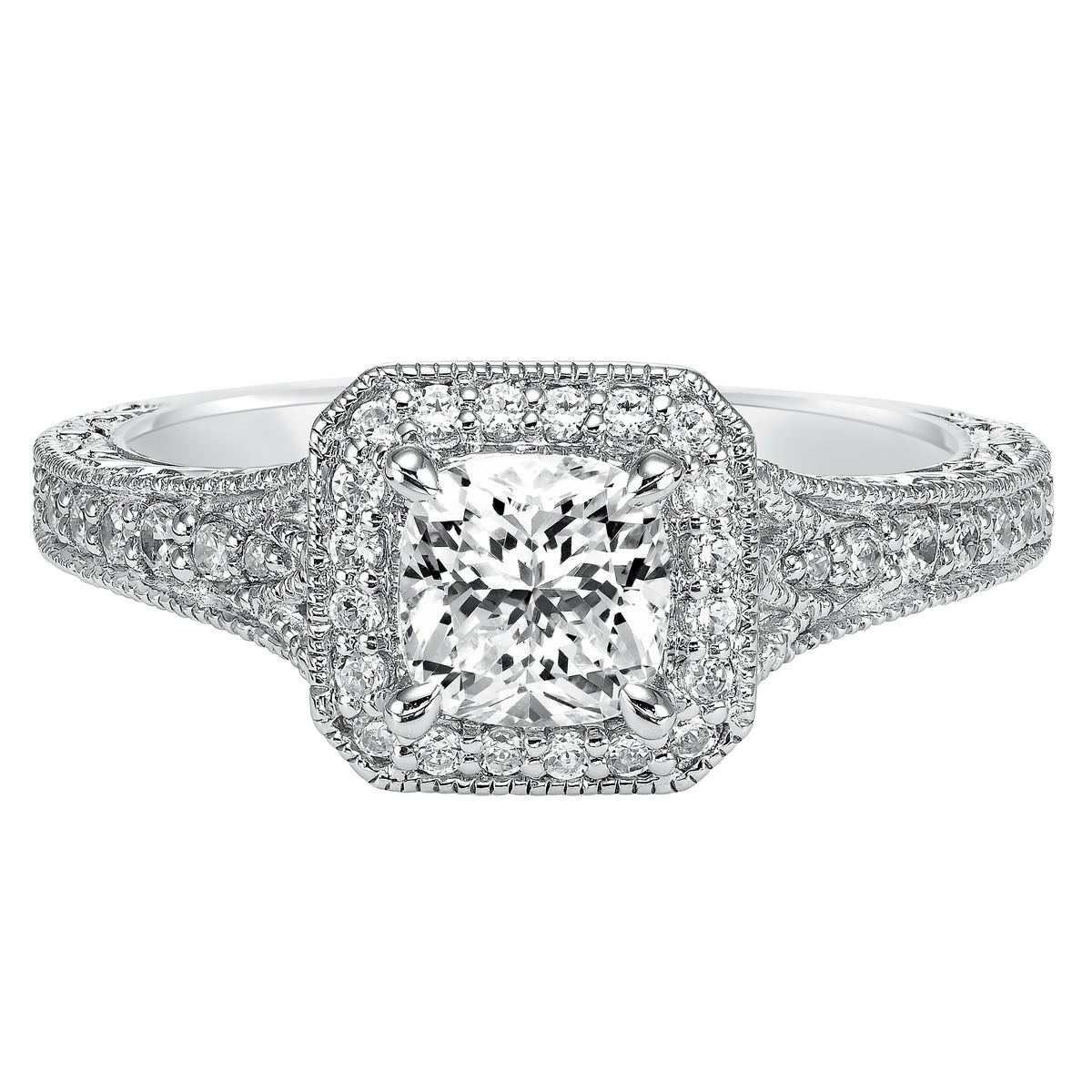 This cushion cut diamond engagement ring dazzles with its stunning prong set diamond halo and band enhanced with milgrain and an engraved design