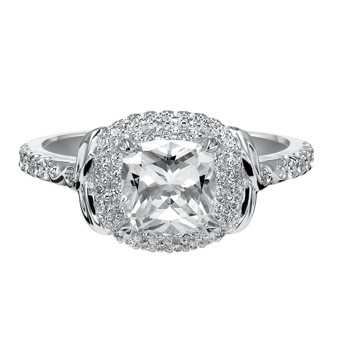 This cushion cut engagement ring is a show-stopper with its two-row diamond prong set halo, high polished accents and delicate prong set diamond band