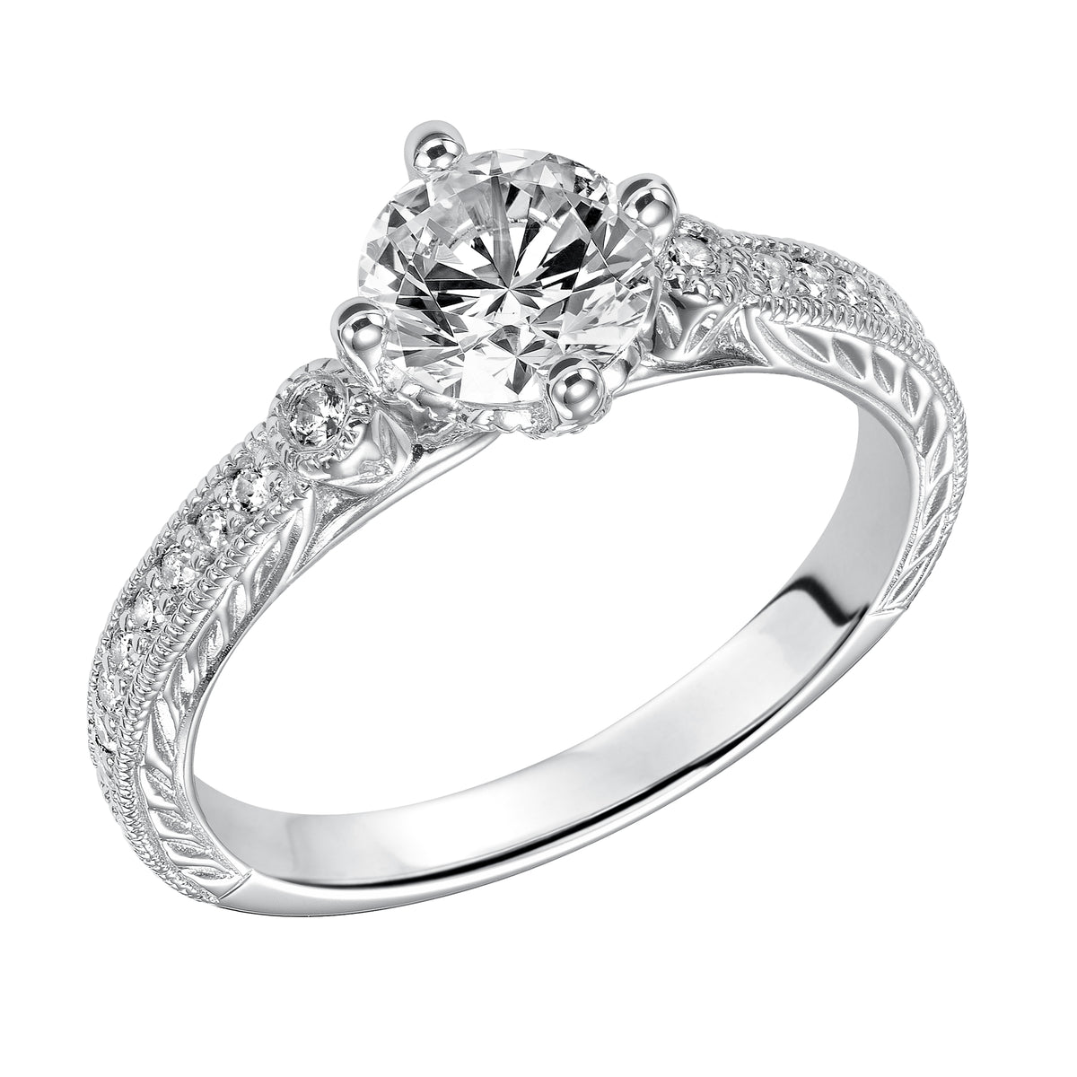 Prong set diamonds, milgrain details and an engraved design grace the band of this exquisite round diamond engagement ring