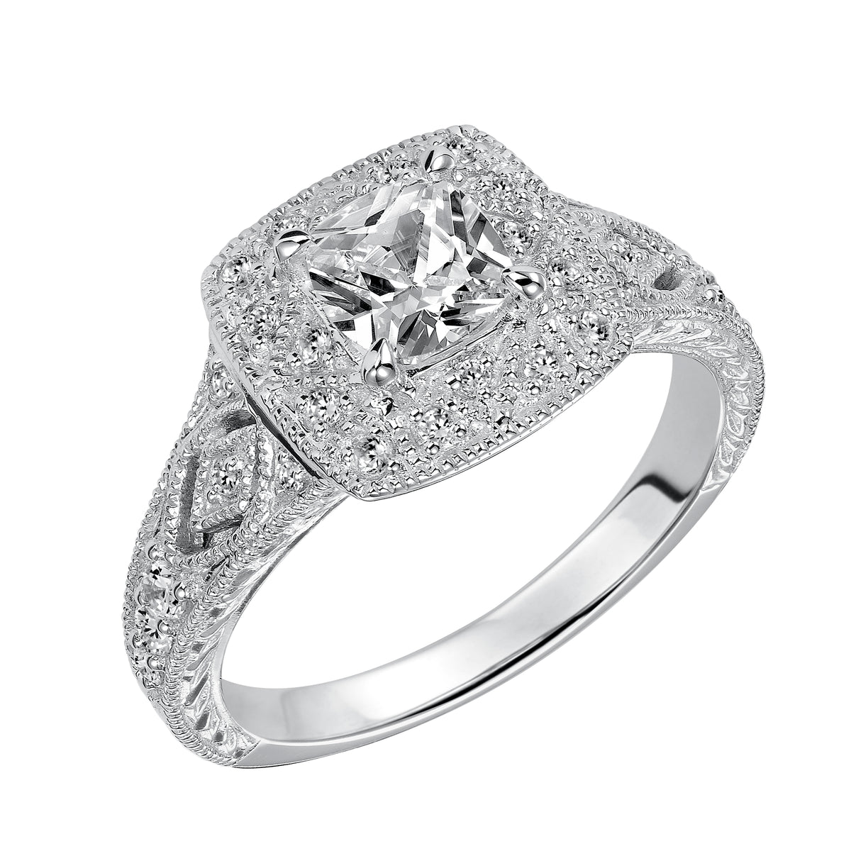 This cushion cut diamond engagement ring features a beautifully dramatic diamond prong set halo and band enhanced with engraving and milgrain