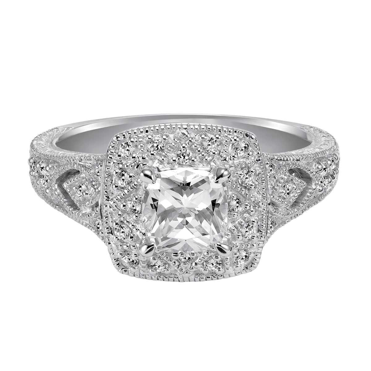 This cushion cut diamond engagement ring features a beautifully dramatic diamond prong set halo and band enhanced with engraving and milgrain