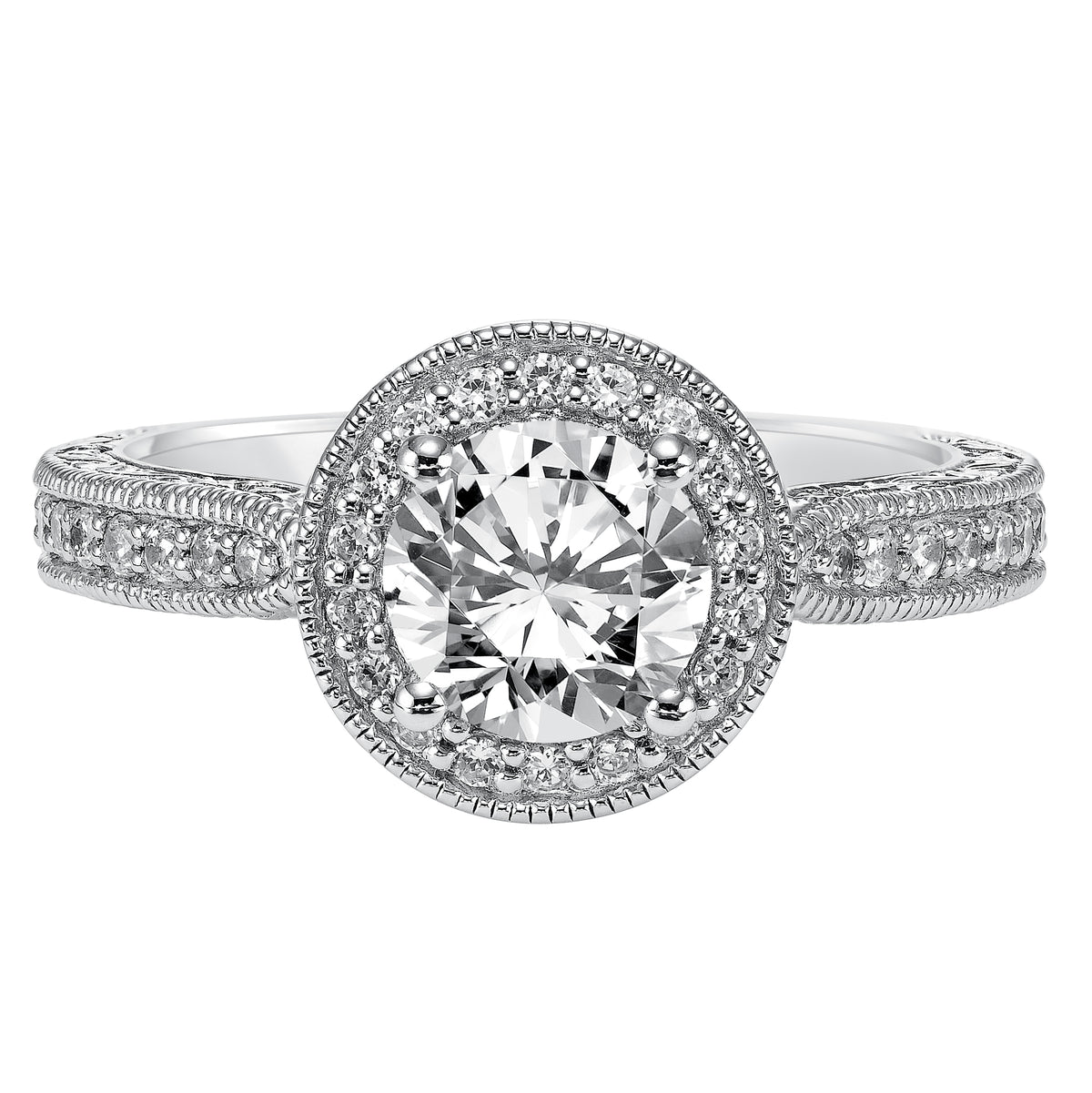 This round diamond engagement ring featuring a prong set diamond halo and band with engraving and milgrain is vintage chic, beautiful and sure to make a statement
