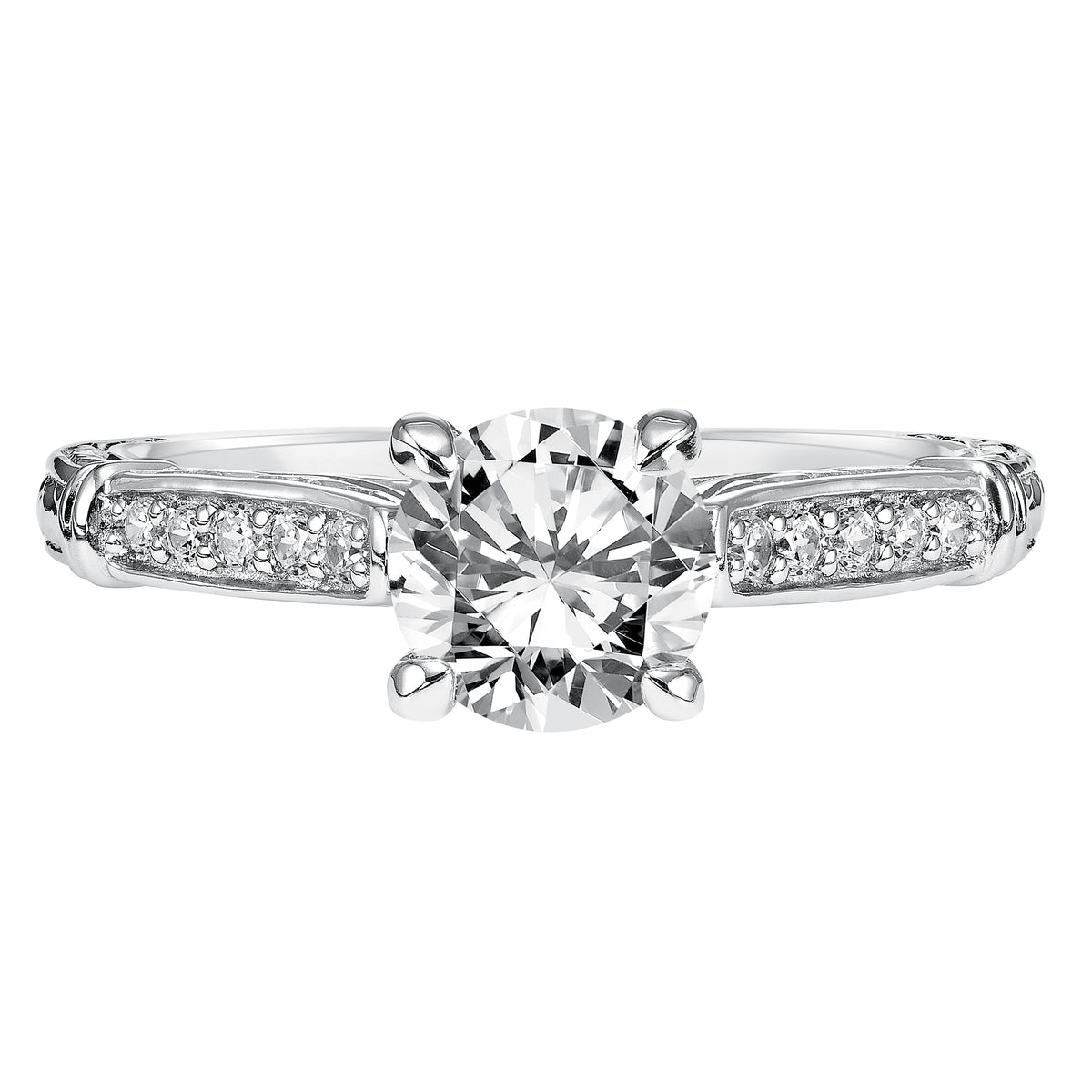 This brilliant round diamond is beautifully paired with this prong set diamond band enhanced with engraving