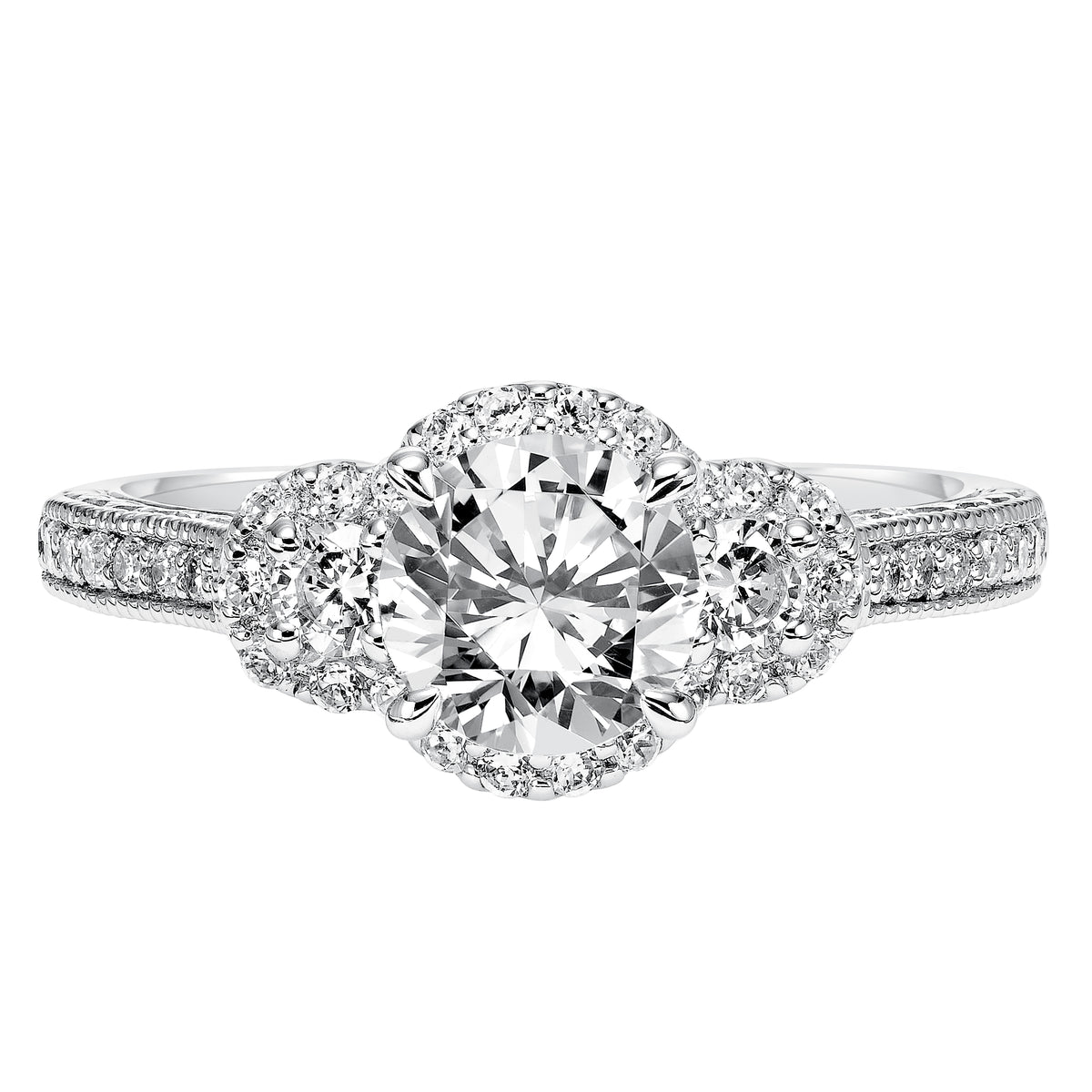 Bold, beautiful and timeless, this prong set diamond band with milgrain and engraving graces the band of this 3-stone diamond halo engagement ring