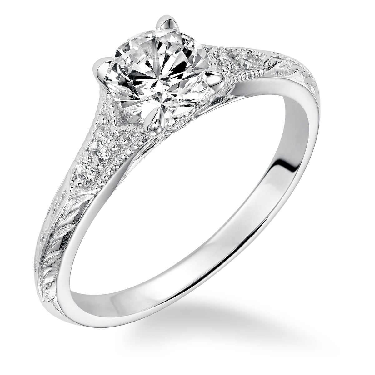 Modern heirloom style inspired the design of this engagement ring featuring a tapered diamond prong set band with milgrain and an engraved design