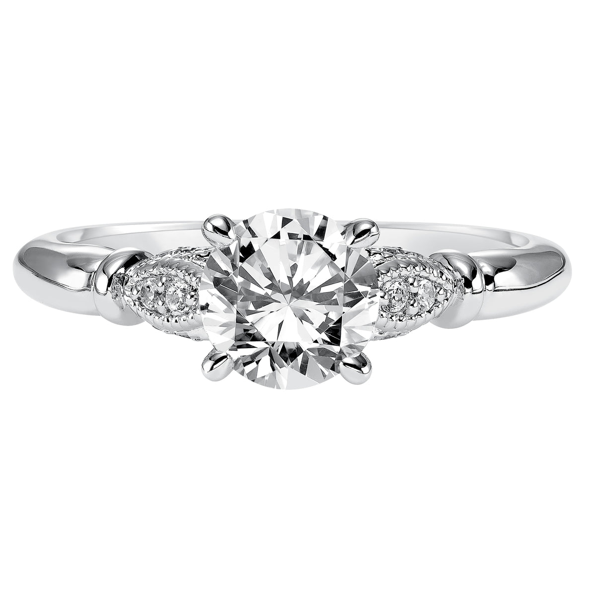 This round diamond engagement ring is simple yet elegant featuring a delicate diamond prong set petal design with milgrain accentuating the center stone on each side