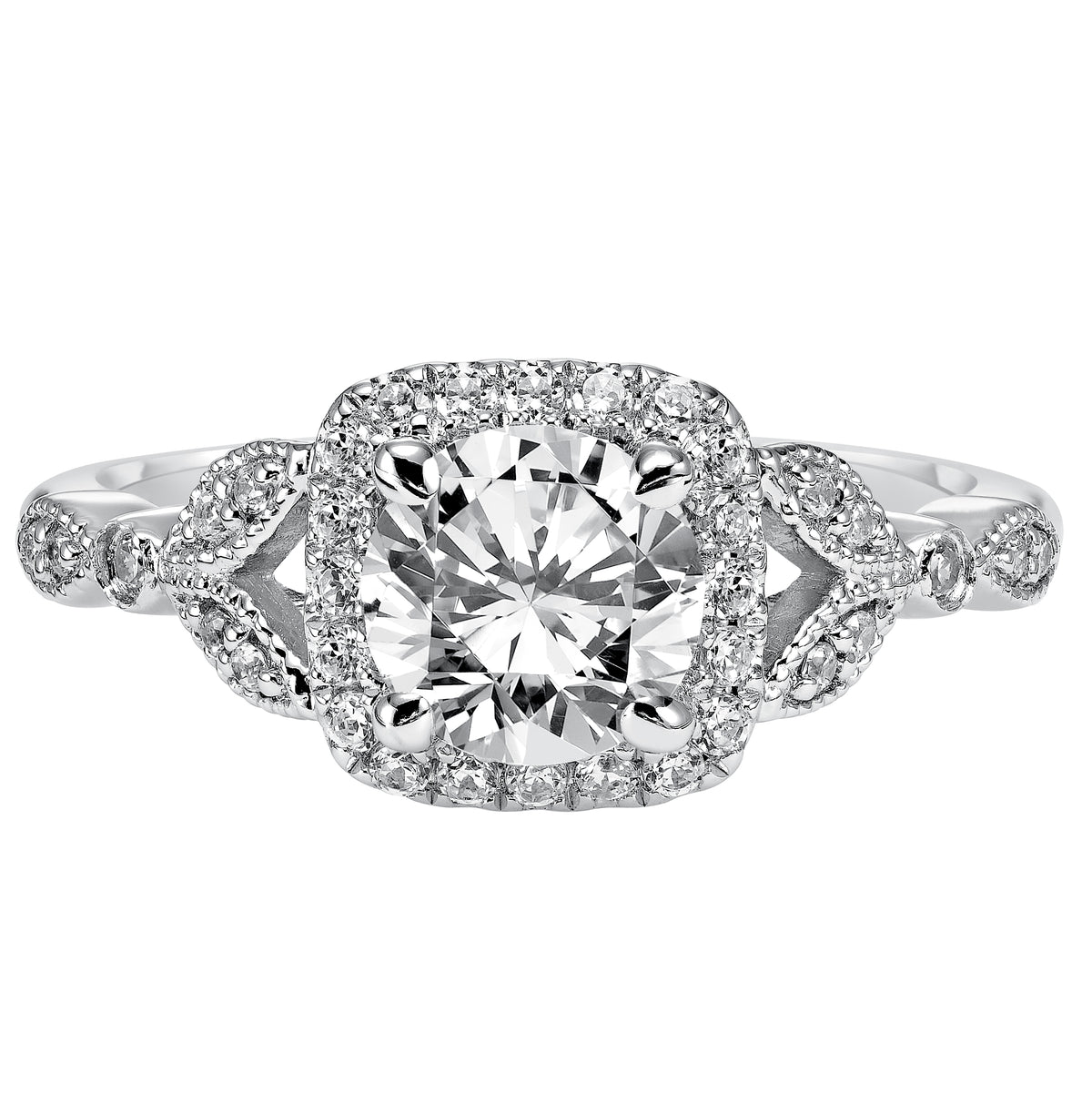 This whimsically styled engagement ring sparkles with its filigree and diamond halo and diamond prong set floral-inspired band